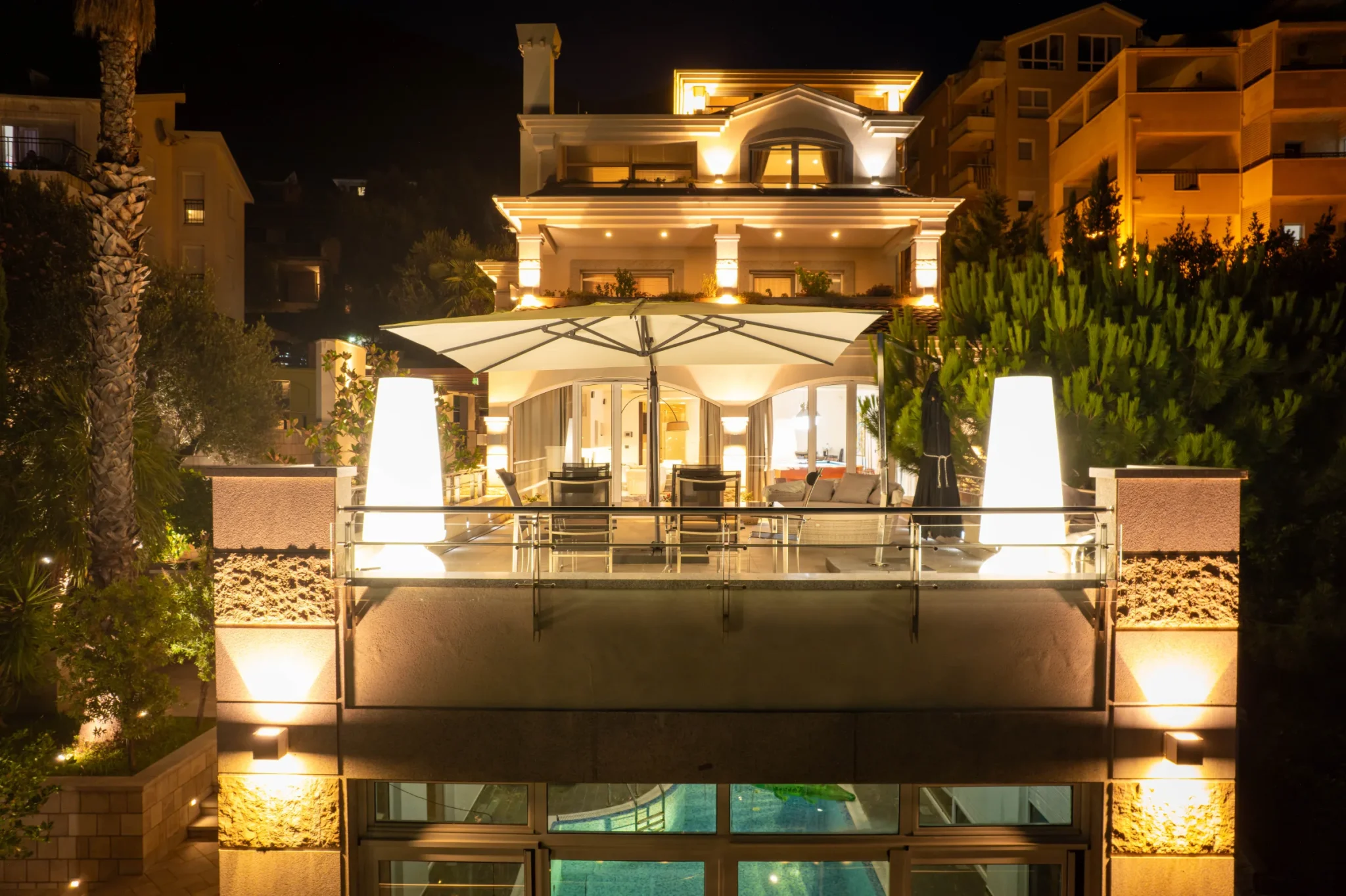 Illuminated terrace and facade of Villa Antares at night